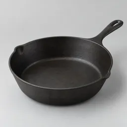 Centered large deep skillet with a dark matte metal surface, shown at a slight three-quarter angle on a neutral light-gray studio background.