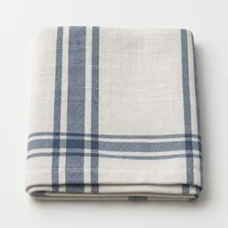 Centered folded woven cotton kitchen towel on a light neutral studio background.