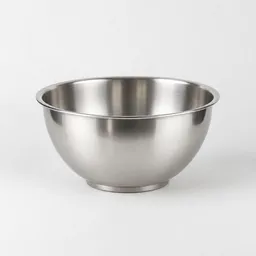 Centered small stainless-steel mixing bowl on a light neutral background with soft studio lighting.