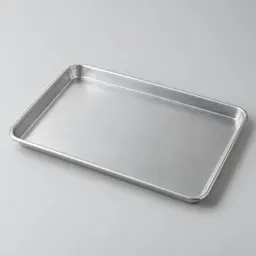 Centered rimmed baking sheet with a raised edge on a neutral light background.