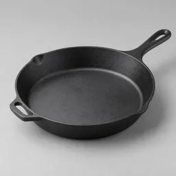 Large matte cast-iron skillet shown fully in frame against a neutral light background.