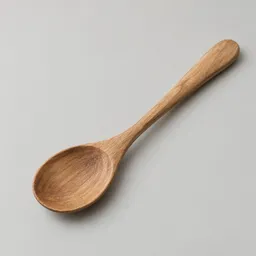 Centered wooden kitchen spoon on a light neutral background.