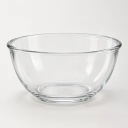 Centered clear glass microwave-safe bowl on a light neutral studio background.