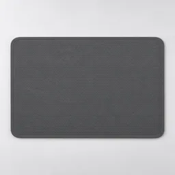Centered charcoal-gray rectangular heat-resistant silicone kitchen mat on a light neutral background.