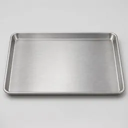 Centered studio photograph of a plain rectangular aluminum baking sheet on a light neutral background.