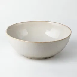Centered empty glazed ceramic slaw bowl photographed on a neutral light background with soft studio lighting.