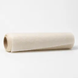 Centered studio photograph of a plain roll of off-white parchment paper on a neutral light background.