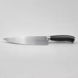 A centered chef’s knife with a broad stainless-steel blade and dark handle photographed on a light neutral background.