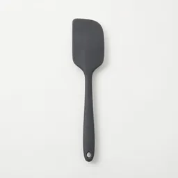 Centered heatproof spatula with a broad matte silicone turner head on a clean light-neutral background.