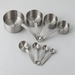 Centered studio photograph of a complete unbranded stainless-steel set of measuring cups and measuring spoons on a neutral light background.
