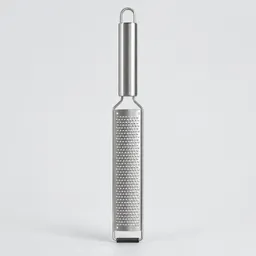 Centered stainless-steel fine grater on a light neutral studio background.