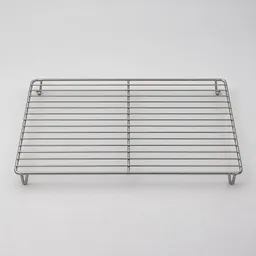 Centered stainless-steel wire cooling rack photographed on a neutral light background.