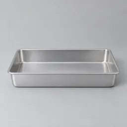 Centered metal baking pan with a raised rim on a neutral light background.