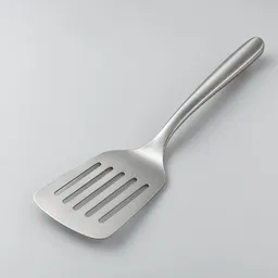 Centered slotted turner with a broad slotted stainless-steel blade and simple handle on a neutral light background.