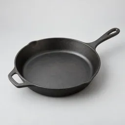 Unbranded 10-inch dark metal skillet shown centered on a light neutral background.