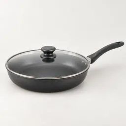 Large dark skillet with a fitted glass lid, centered on a light neutral background.