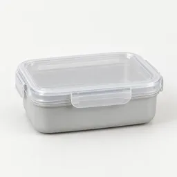 Centered studio photograph of a plain reusable rectangular lunch container with a translucent lid on a light neutral background.