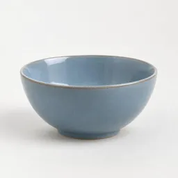 Centered realistic ceramic kitchen bowl photographed against a light neutral background with soft studio lighting.