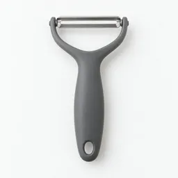 Centered studio photograph of a single vegetable peeler on a neutral light background.