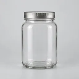 Centered unbranded glass kitchen jar with a plain lid on a neutral light background.