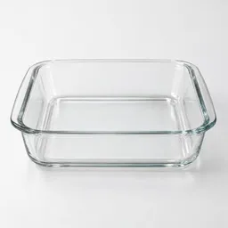 Centered empty 9-inch square glass baking dish on a neutral light background.