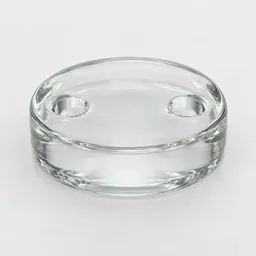 Clear glass fermentation weight with two finger holes, photographed centered on a neutral light background.