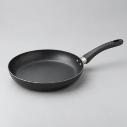 Centered nonstick skillet with a dark round cooking surface and long handle on a neutral light background.