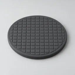 A round dark gray silicone heatproof trivet photographed centered on a light neutral background.