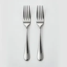 Two clean stainless-steel dinner forks centered on a plain light background.