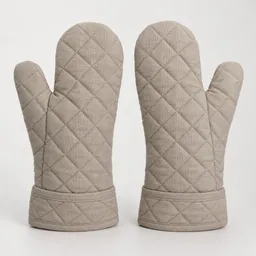 Centered pair of dry quilted oven mitts on a neutral light studio background.