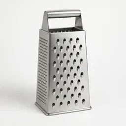 Centered stainless-steel box grater photographed upright on a neutral light background.