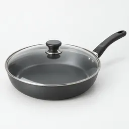 Large dark nonstick skillet with a transparent glass lid, centered on a neutral light background.